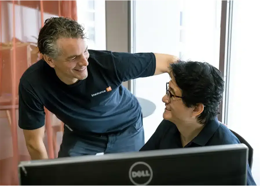 Hassan helping a colleague at her desk