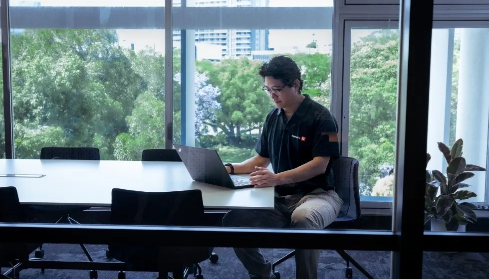 Insource IT engineer working at a laptop in the office
