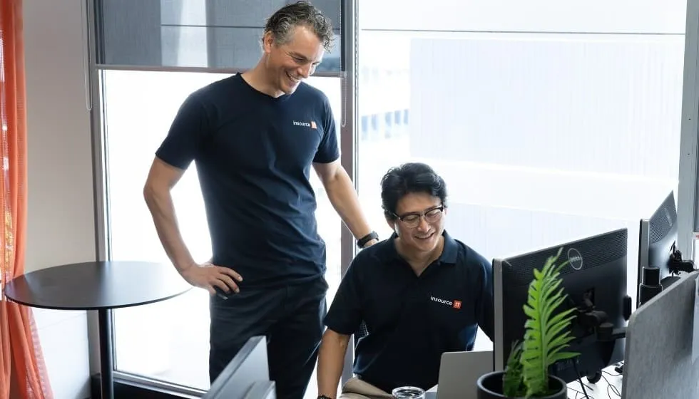 Insource IT consultant working with a client at a computer