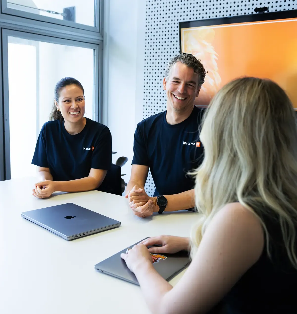 Insource IT team members in a meeting with a client